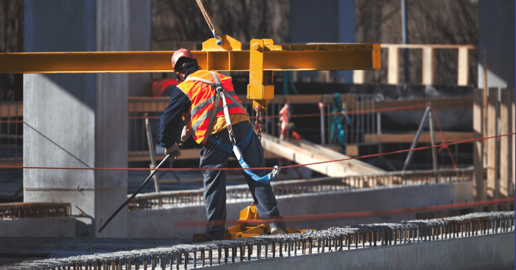 Construction worker tethered to safety harness